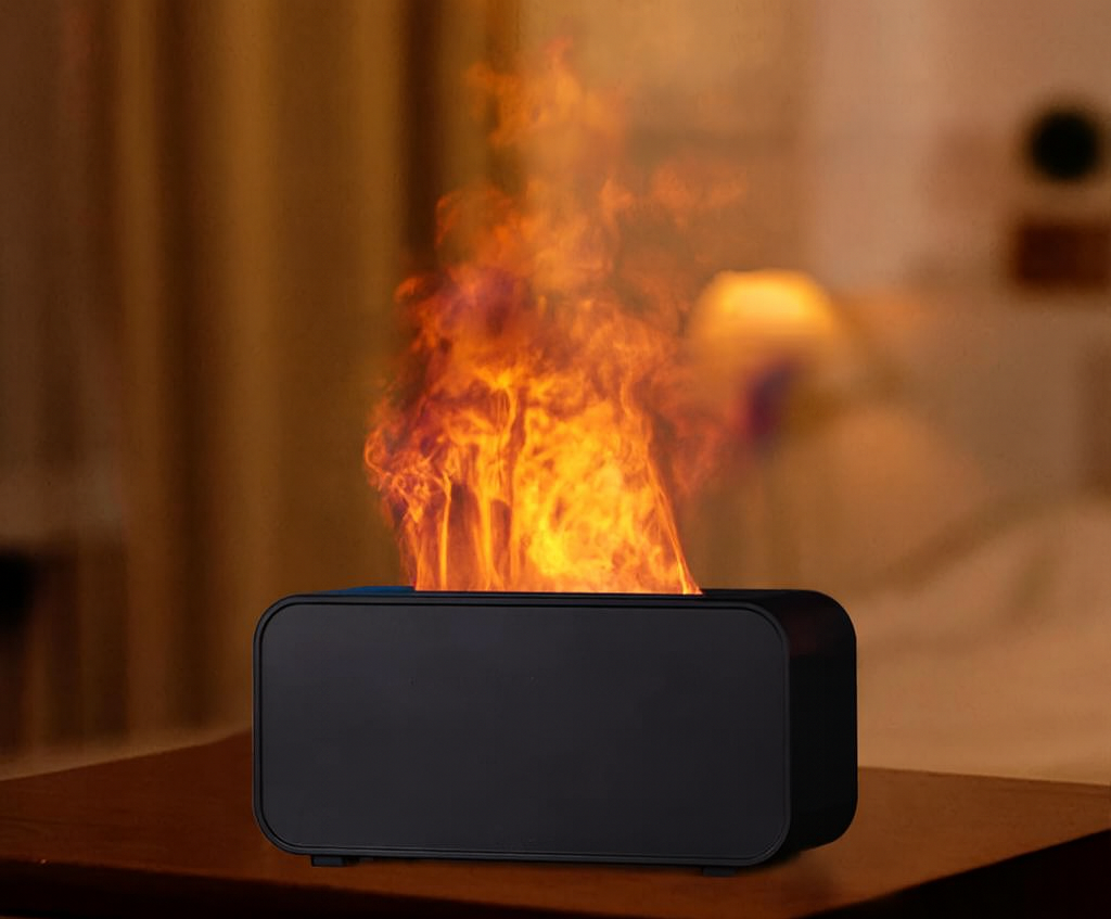 Black flame diffuser emitting realistic orange fire mist with 1H 3H 5H timer settings and multiple color modes displayed below.